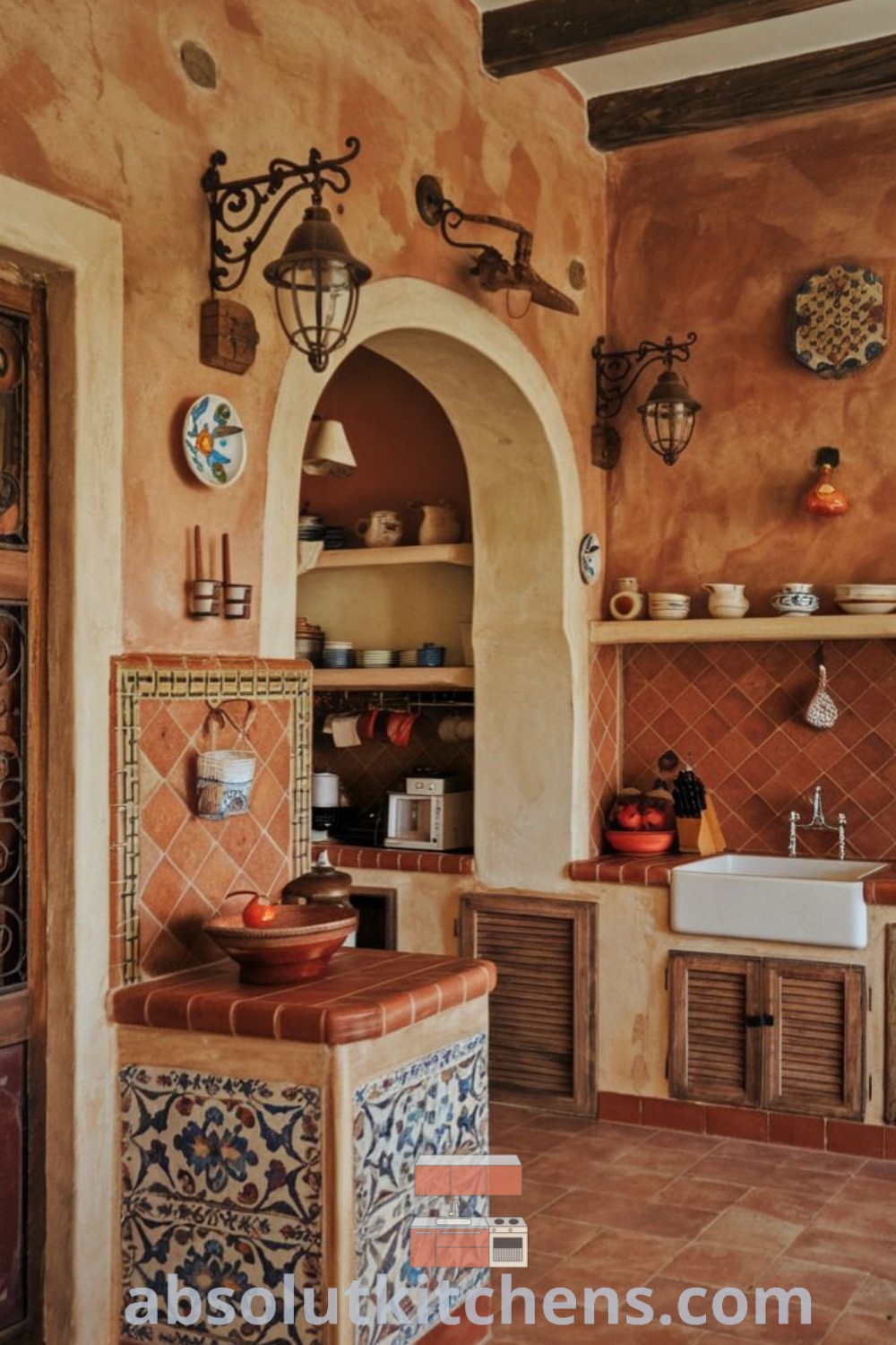 A cozy small kitchen in Spanish style featuring an oven, sink, and counter top surrounded by a terracotta backsplash, large farmhouse sink, and iron light fixtures. This Mediterranean kitchen decor offers inspiring design ideas for small spaces, making it a functional and inviting area for any home. Discover more at absolutkitchens.com.