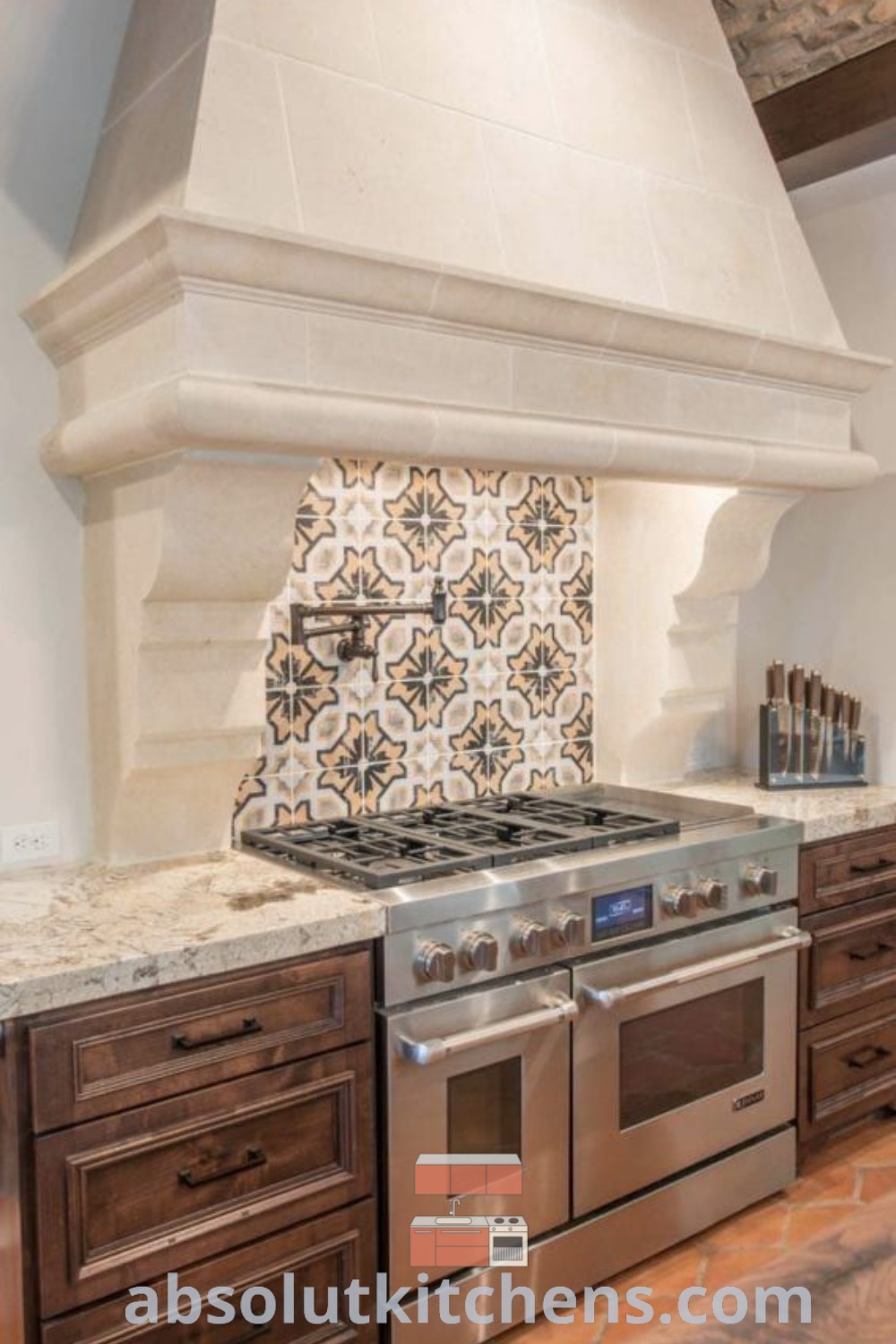 A Mediterranean kitchen showcasing a stove top oven next to wooden cabinets and countertops, embodying rustic Italian and Tuscan kitchen design elements. This inspiring space features Spanish style kitchen decor, perfect for cozy aesthetics. Explore design trends and decorating ideas at absolutkitchens.com.
