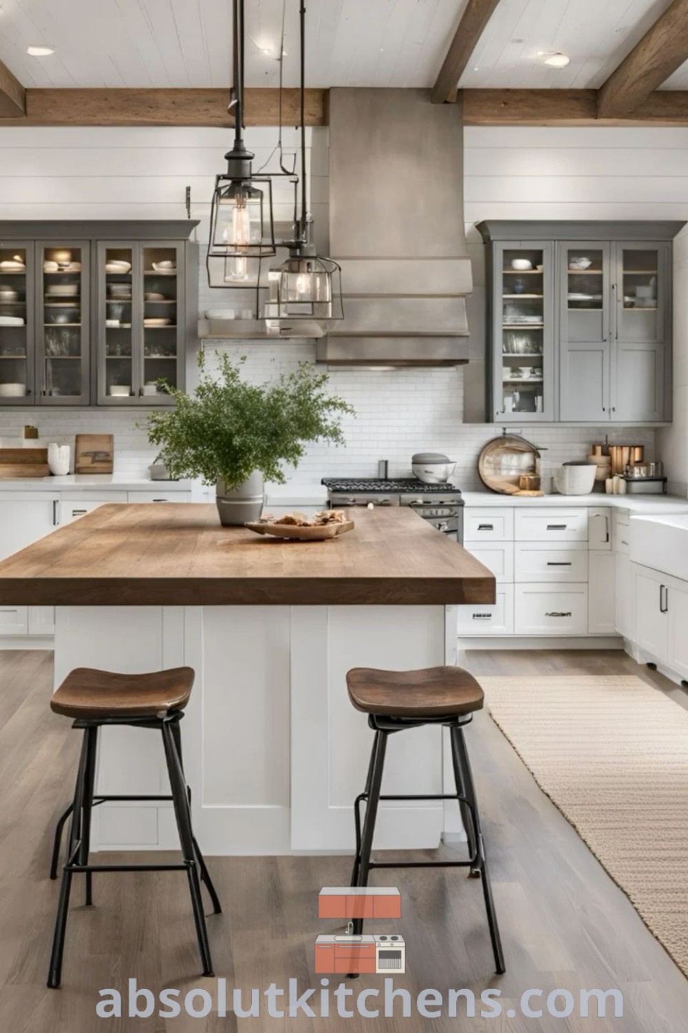 A spacious modern farmhouse kitchen with a central island, two stools, and beautiful wood flooring, offering design ideas for a cozy and functional space. This image from absolutkitchens.com showcases inspiring decor ideas, including trendy kitchen styles and easy DIY tips for your home.
