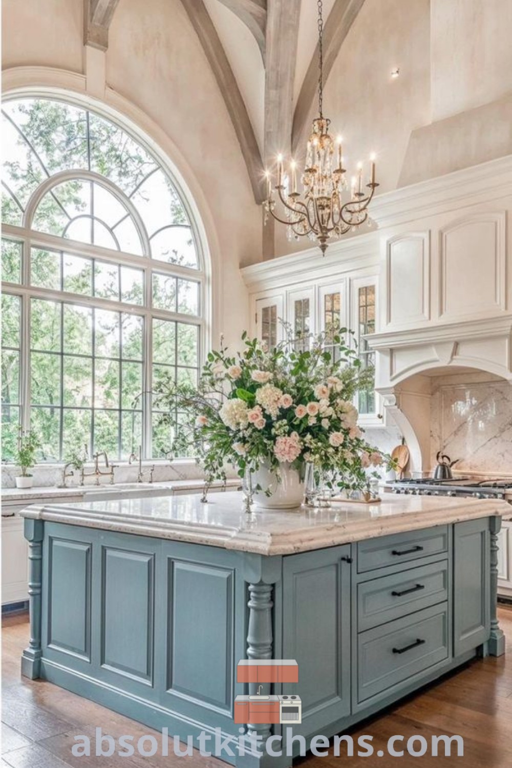A large farmhouse kitchen with an island, chandelier, and ample windows creating a cozy aesthetic. This kitchen renovation showcases decor ideas for small spaces while blending cottage style with home décor. For more design tips, visit absolutkitchens.com.