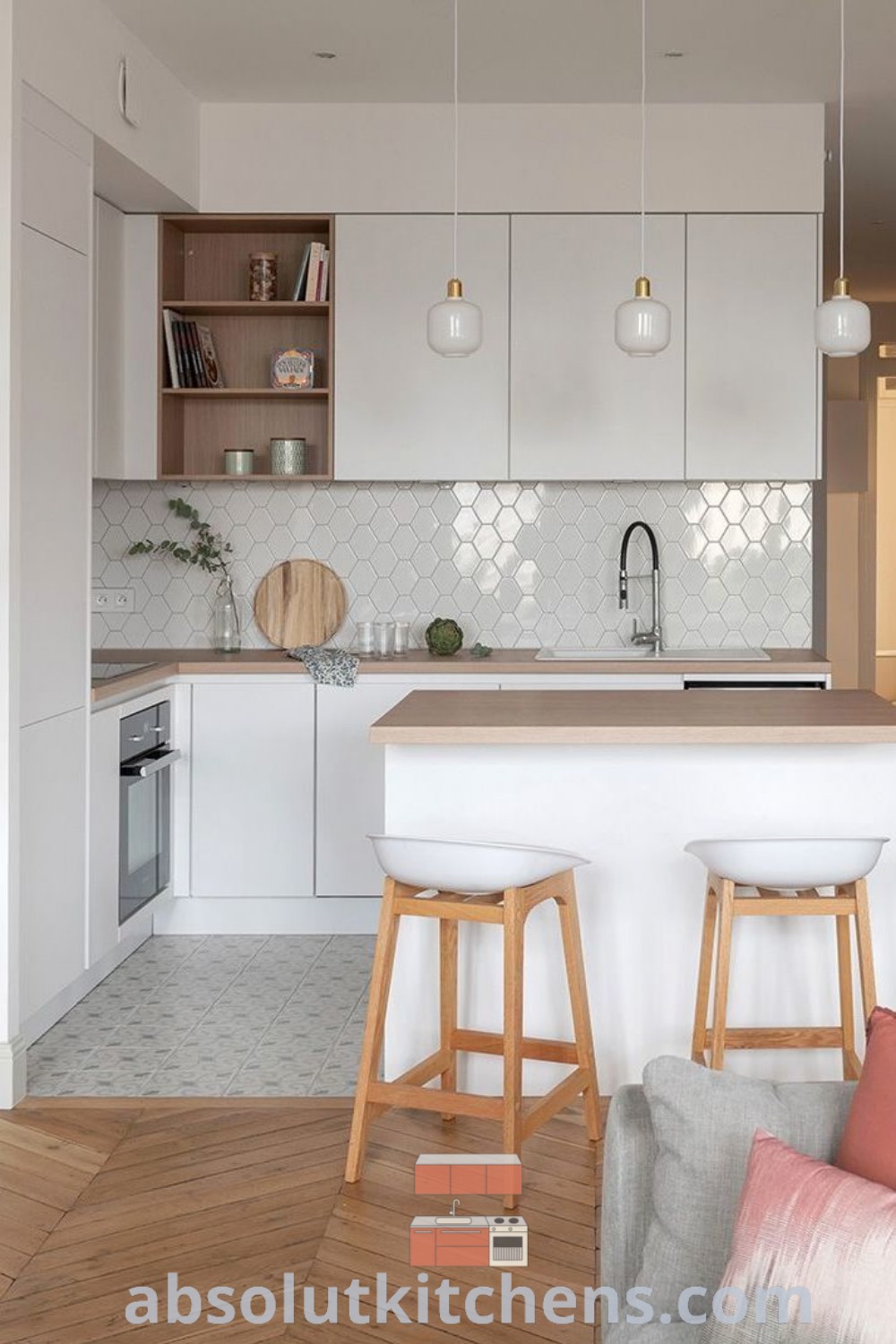 A modern kitchen with two stools in front of an island, showcasing decor ideas for small apartment kitchens. The design features elegant cabinets and shelves, creating a cozy home atmosphere. For more inspiring kitchen designs and decor inspirations, visit wellnesswink.com.