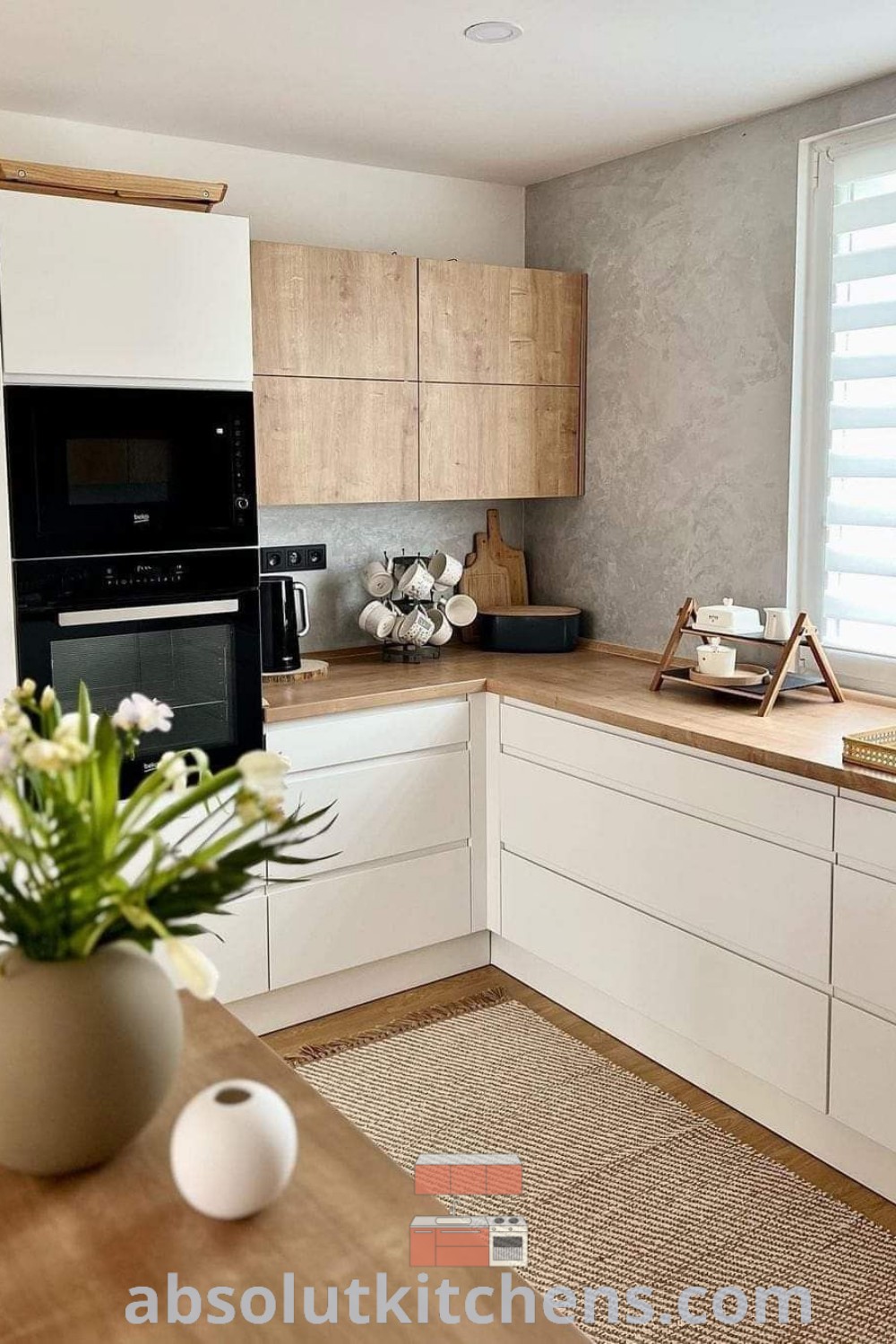 A cozy kitchen design showcasing a vase of flowers on a kitchen counter, complemented by beautiful kitchen cabinets and modern kitchen interiors. This setup offers unique ideas and inspiration for your home, enhancing your kitchen