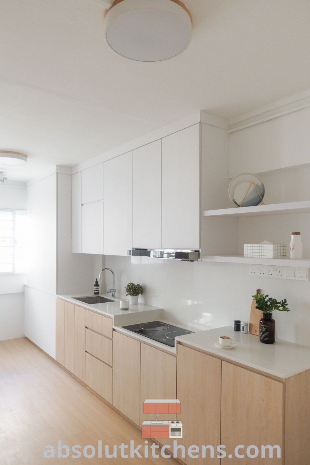 A cozy kitchen with white cabinets, a gold faucet on the countertop, and a vase filled with flowers, showcasing unique interior decorating ideas. This charming space emphasizes kitchen decorating ideas and designs, perfect for small balcony decor inspirations, found at wellnesswink.com.