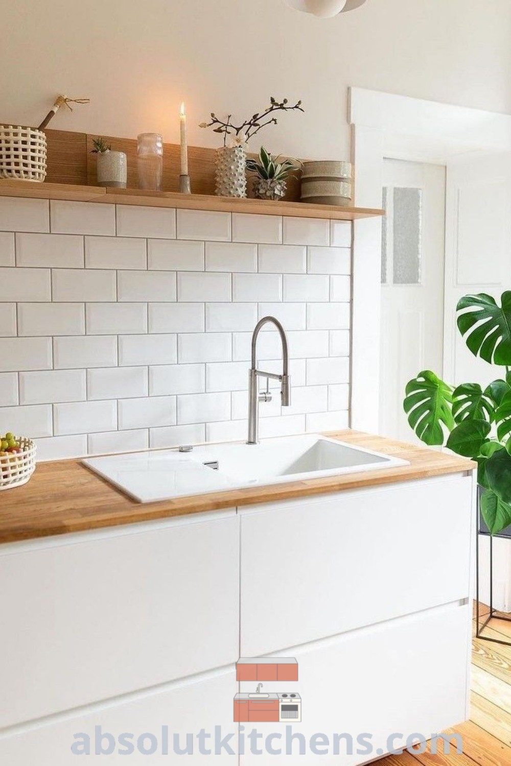 A cozy kitchen with white cabinets, wooden countertops, and a basket on the stool, illustrating kitchen design plans and decor inspirations for a charming home. Discover more unique ideas and kitchen inspiration designs at wellnesswink.com.