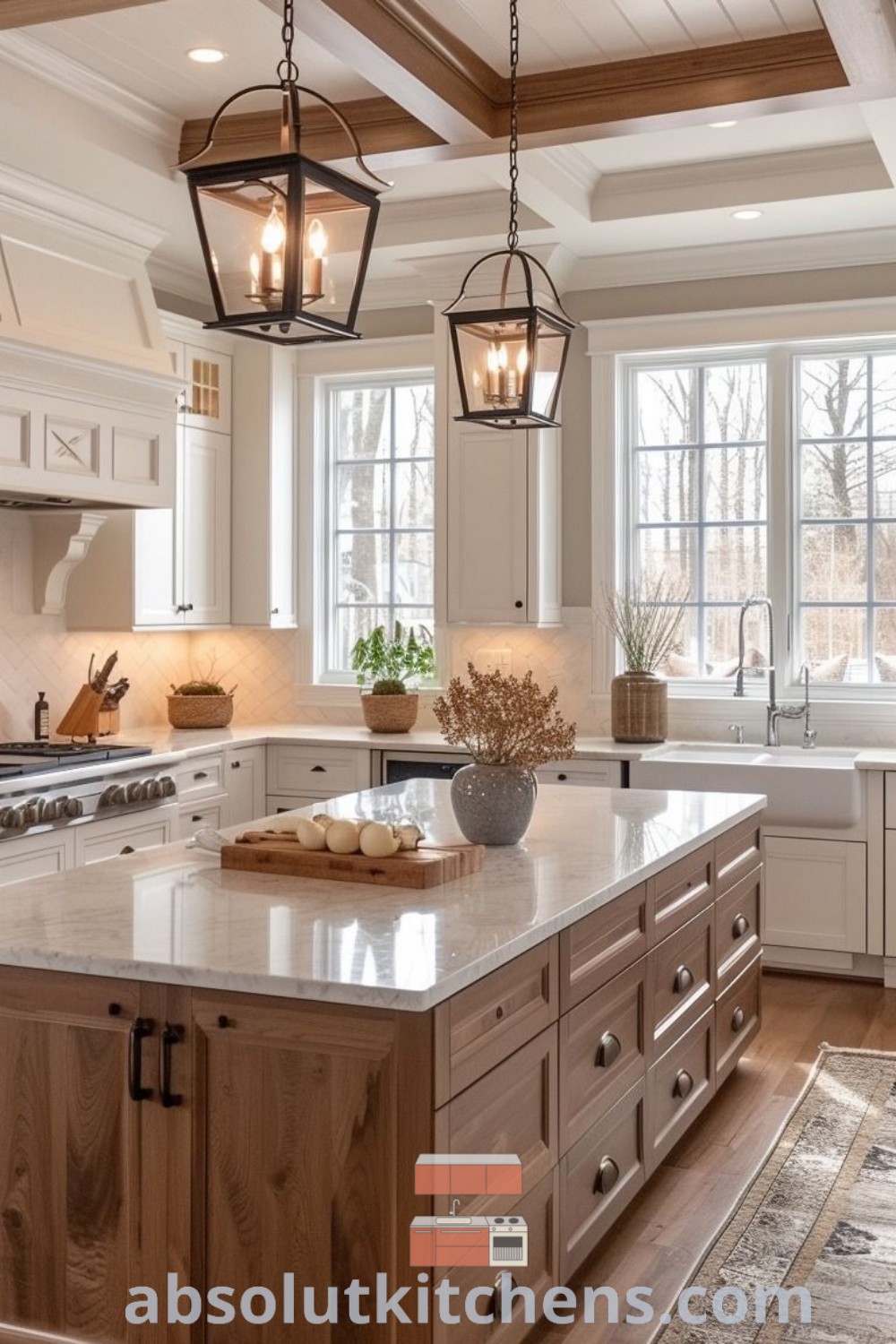 A large rectangular kitchen island with hanging lights above, situated in a spacious kitchen layout. This design showcases modern kitchen island ideas and decor tips for creating cozy aesthetics in your home. Find inspiration for your kitchen revamp at absolutkitchens.com.