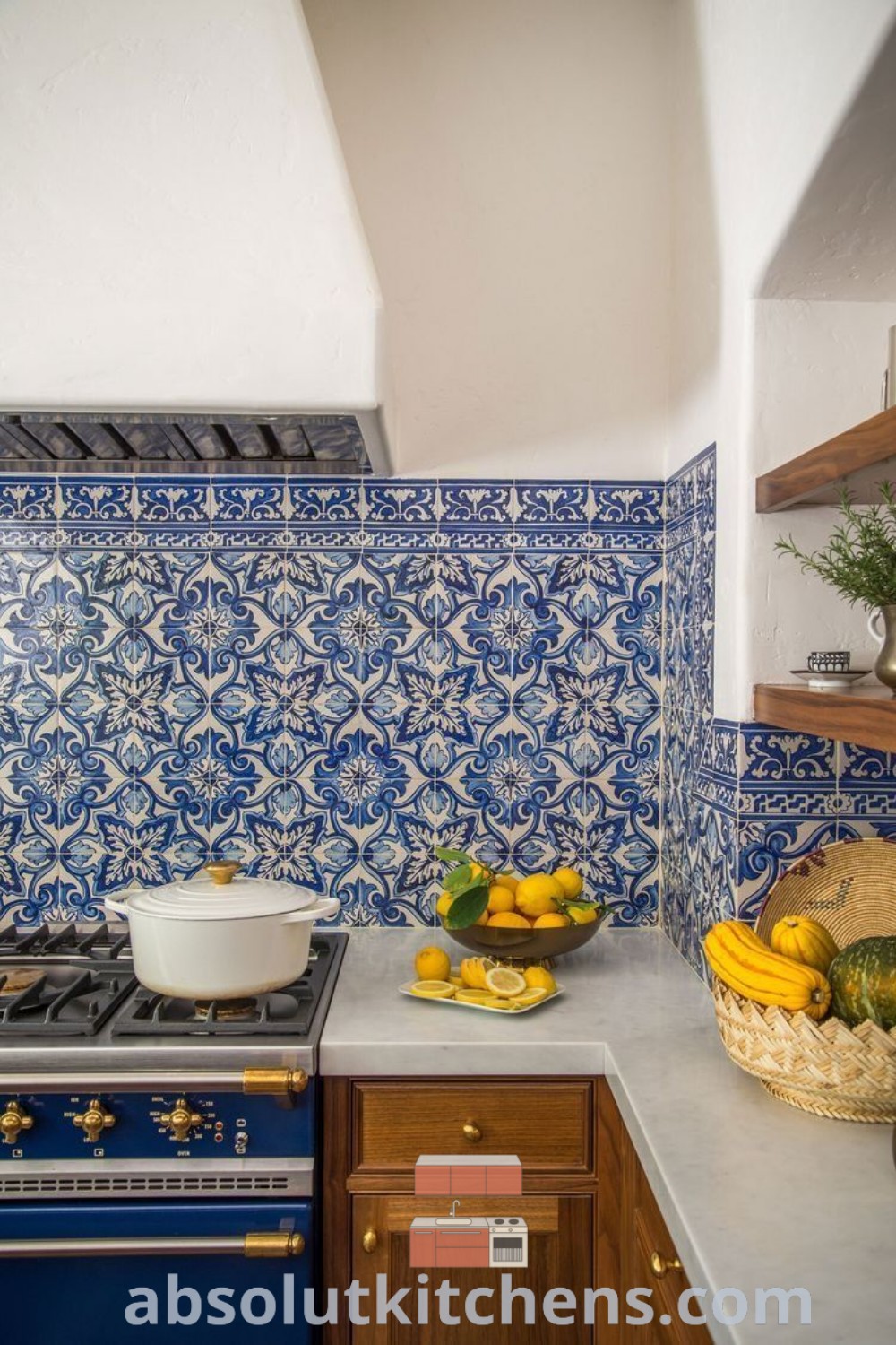A modern kitchen featuring a blue and white tile backsplash, showcasing elegant design trends and cozy aesthetic elements. This kitchen decor idea is perfect for anyone seeking inspiring house decor for their future homes. Explore more ideas at absolutkitchens.com.