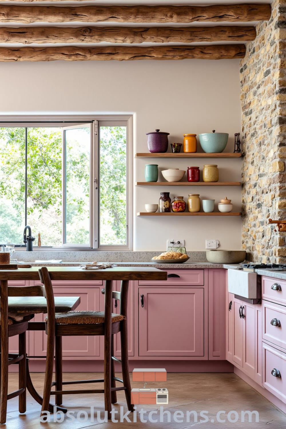 A cozy rustic kitchen with soft pink accents, featuring a sturdy farmhouse table surrounded by mismatched chairs, handmade pottery on open shelves, and sunlight streaming through a window, offering decor inspirations for a warm and inviting home at fireplacesandwoodstoves.com.