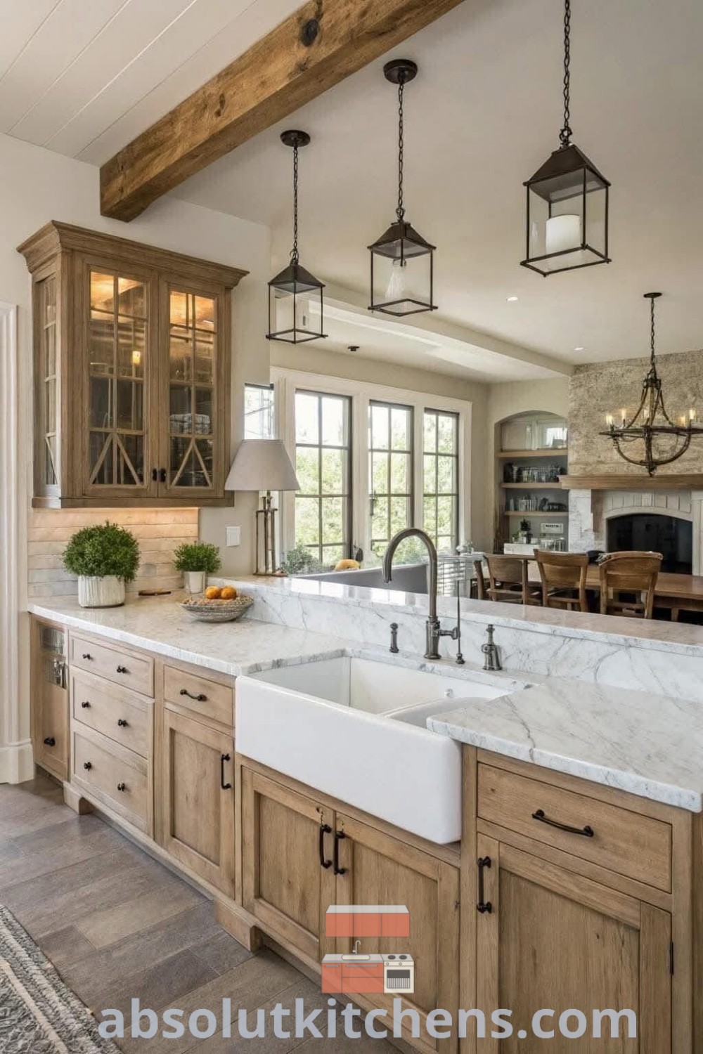 A modern kitchen with wooden cabinets and marble countertops, showcasing an island-style sink and hanging lights. This inviting space offers ideas for modern farmhouse kitchen wood accents, emphasizing a cozy aesthetic and practical design trends. Explore more decor ideas for your home at absolutkitchens.com.