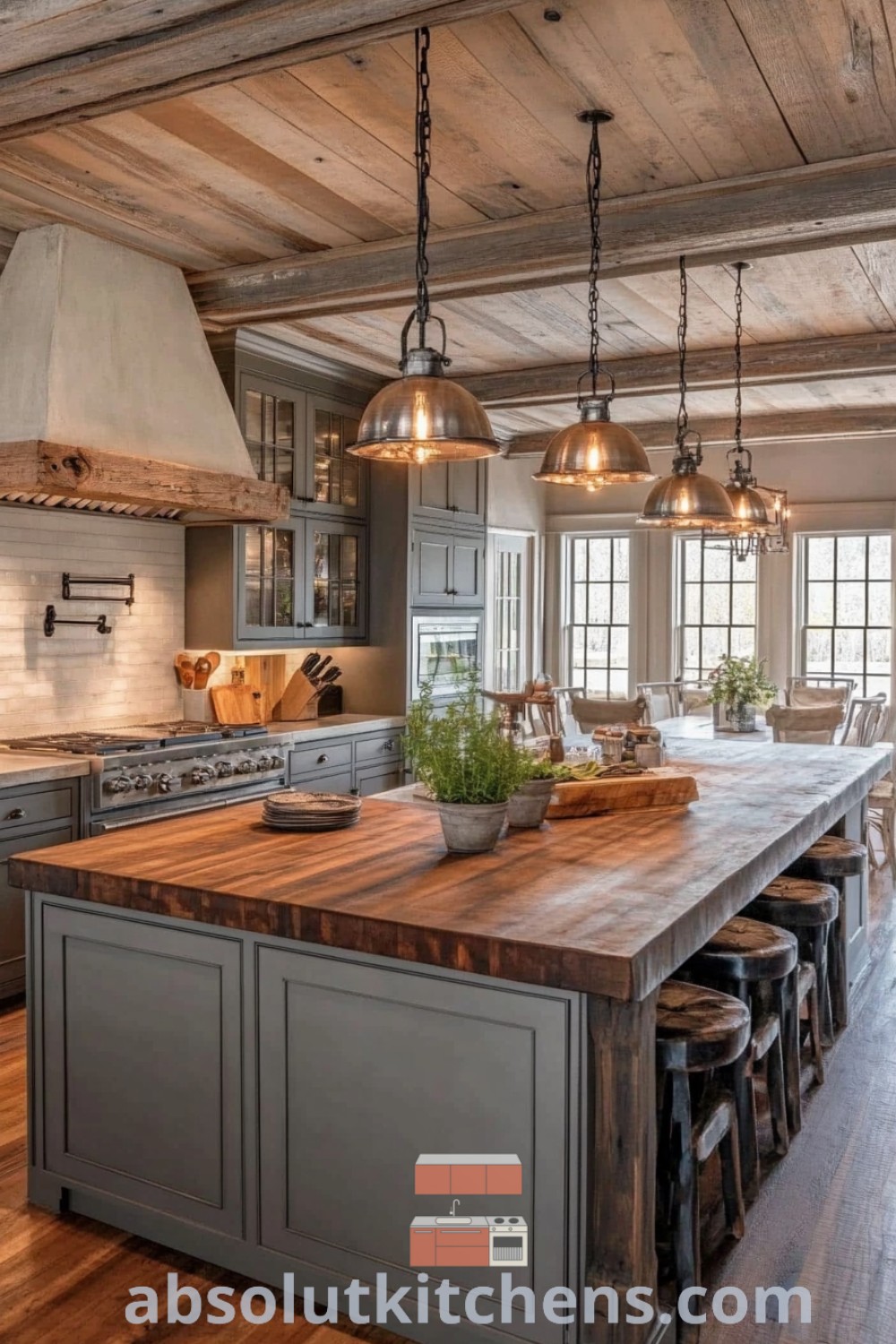 A large kitchen island with stools and pendant lights, showcasing a working farmhouse kitchen design. This massive kitchen island represents current design trends and decor ideas for a cozy, open-concept space. Explore more inspirations at absolutkitchens.com.