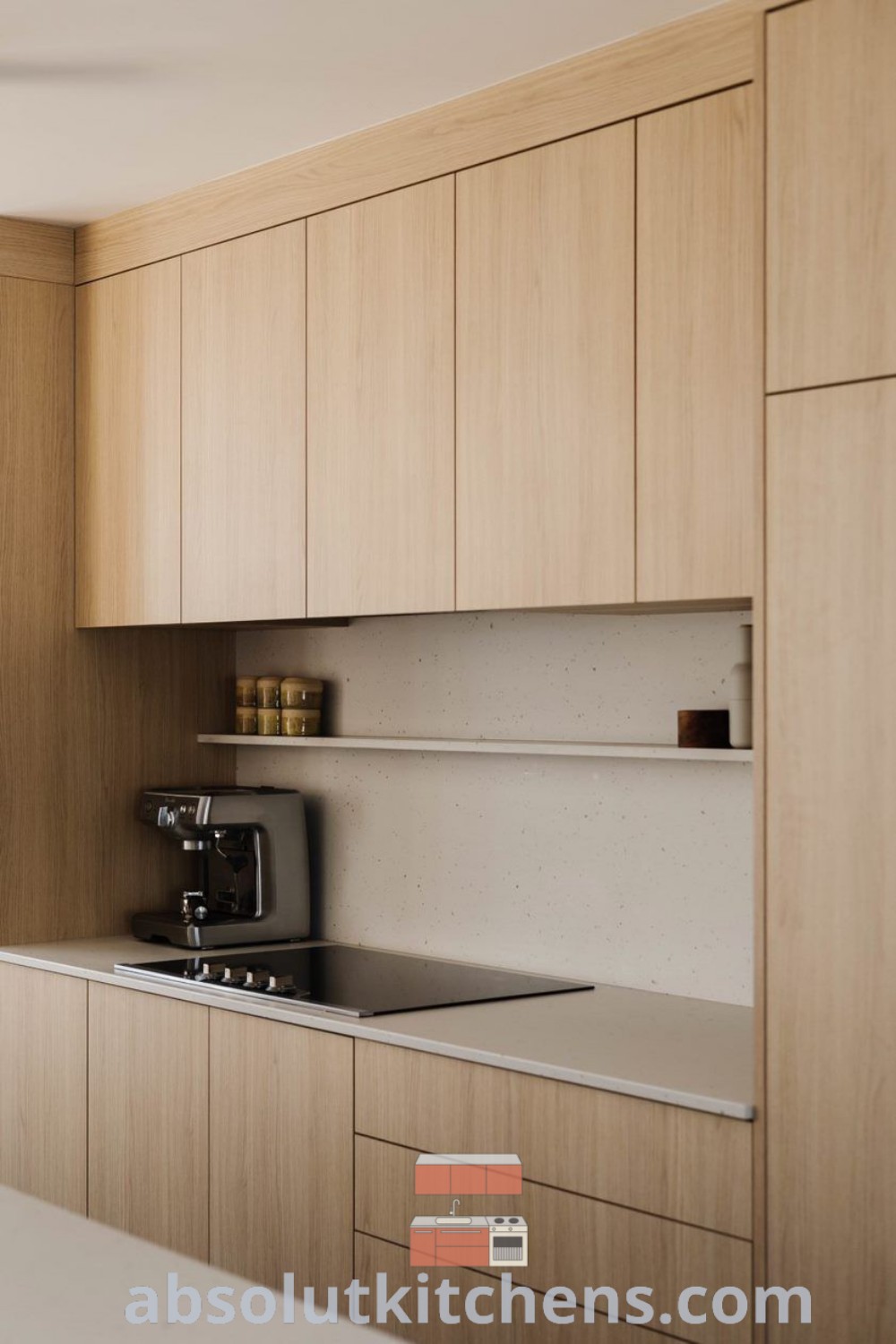A minimalist kitchen featuring two stools in front of a white countertop island and beige cabinets, showcasing neutral tones and contemporary design ideas. This space embodies a cozy home aesthetic with practical elements. Discover more inspiration and decor ideas at wellnesswink.com.