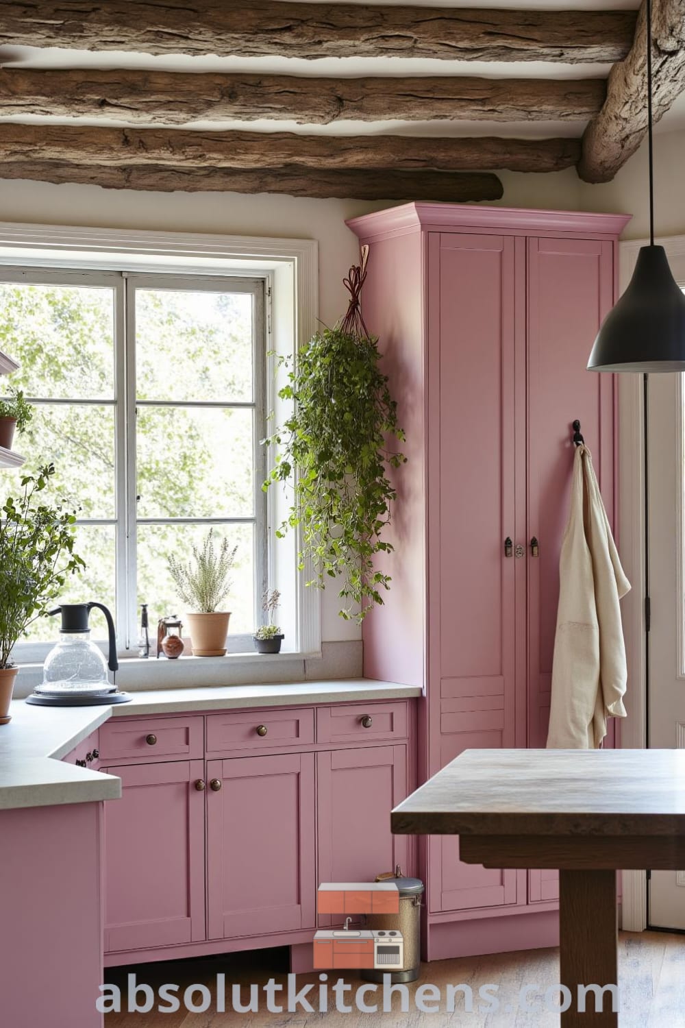 A cozy rustic kitchen featuring soft pink tones, weathered wood cabinets, a farmhouse table, and dried herbs, with sunlight illuminating the space for a warm atmosphere, providing unique decor inspirations and ideas for your home at fireplacesandwoodstoves.com.