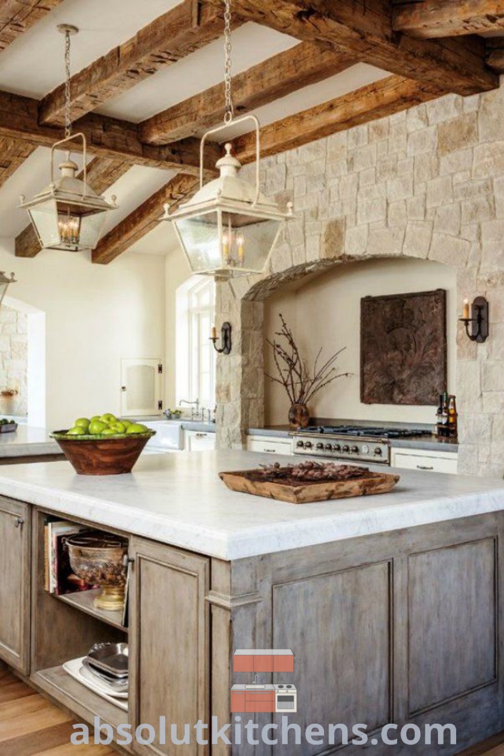 A beautiful European farmhouse kitchen showcasing stone walls, wood beams, and a large center island, offering functional design trends and cozy decor ideas for house or apartment. Find inspiring kitchen decor ideas at absolutkitchens.com.