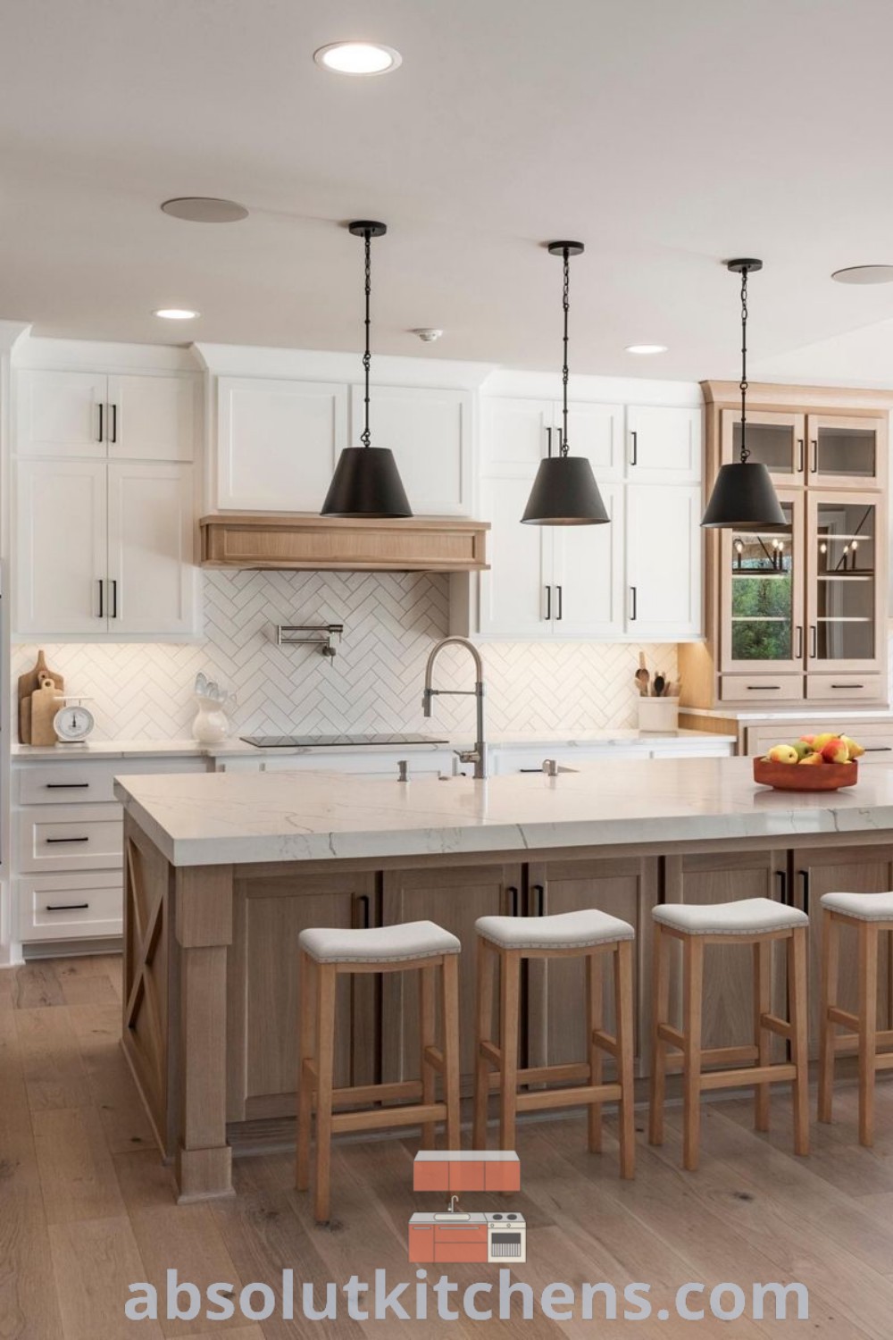 A spacious kitchen with white cabinets and wooden flooring, featuring an inviting island in the center, showcasing modern kitchen decoration ideas. Discover design tips and trends for a new house at absolutkitchens.com, perfect for inspiring decor ideas in your home.