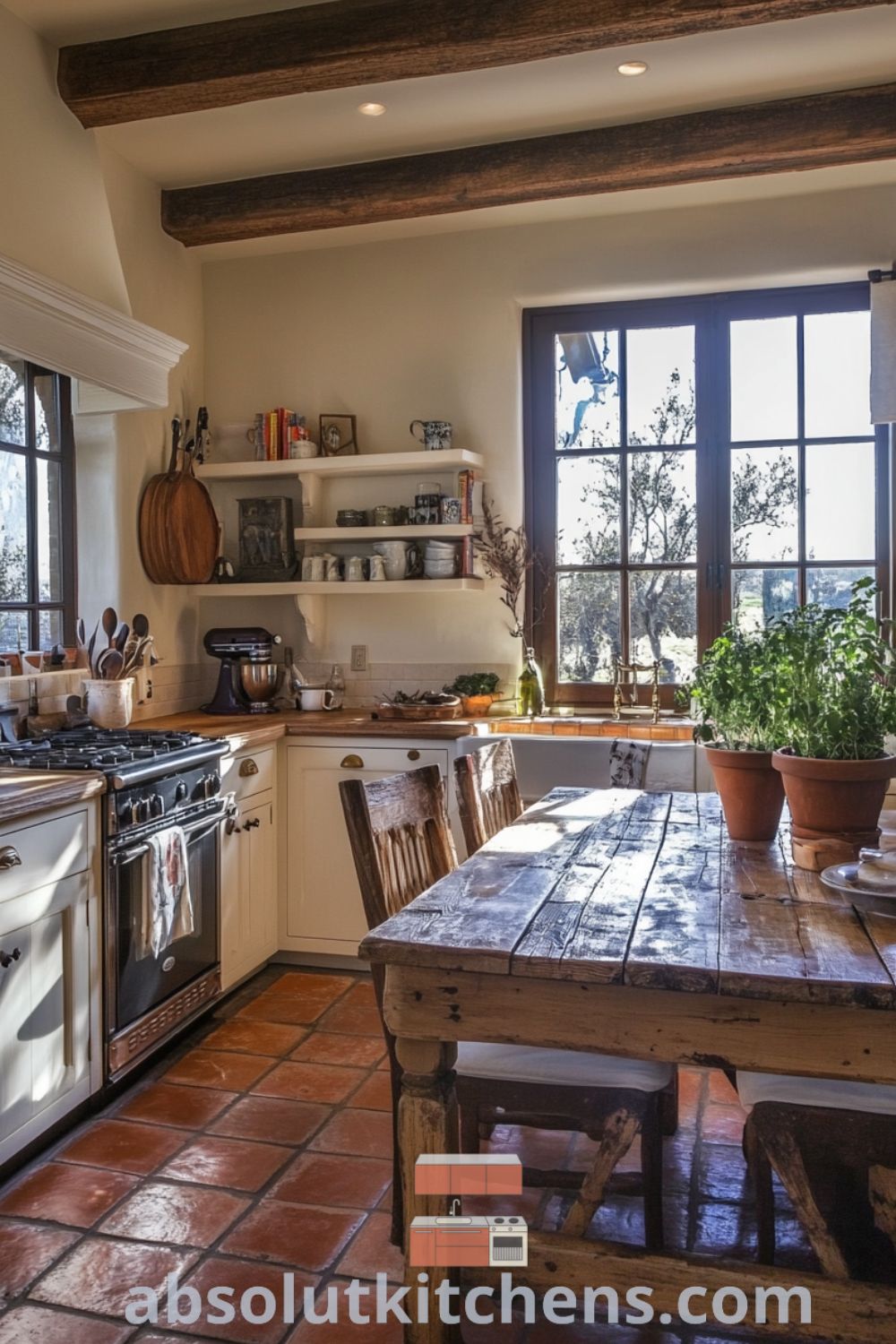 Cozy French kitchen with terracotta tiles, vintage wooden table, pale cream cabinetry, and large sunlit window framing a blossoming herb garden, offering inspiring decor ideas for a warm and inviting home. Visit absolutkitchens.com for unique ideas.
