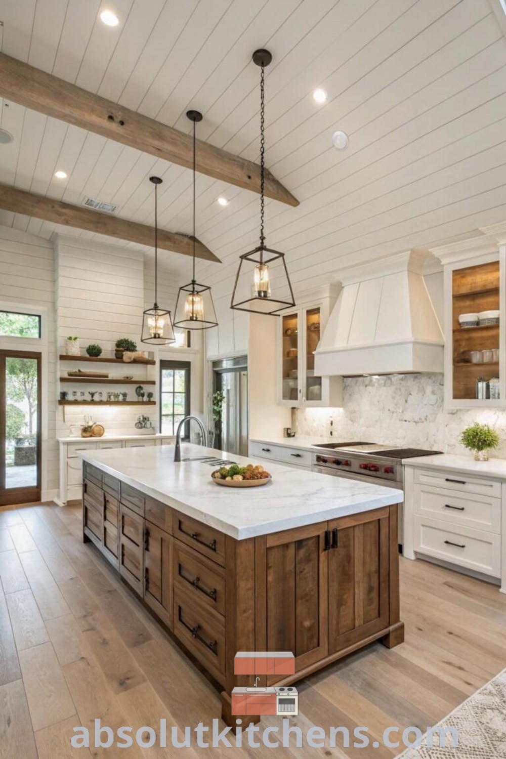 A large modern kitchen with an island in the center, illuminated by numerous hanging lights and featuring neutral tones with black accents. This inspiring kitchen embodies design trends for modern ranch-style homes and offers decor ideas for small spaces. Explore more kitchen designs at absolutkitchens.com.