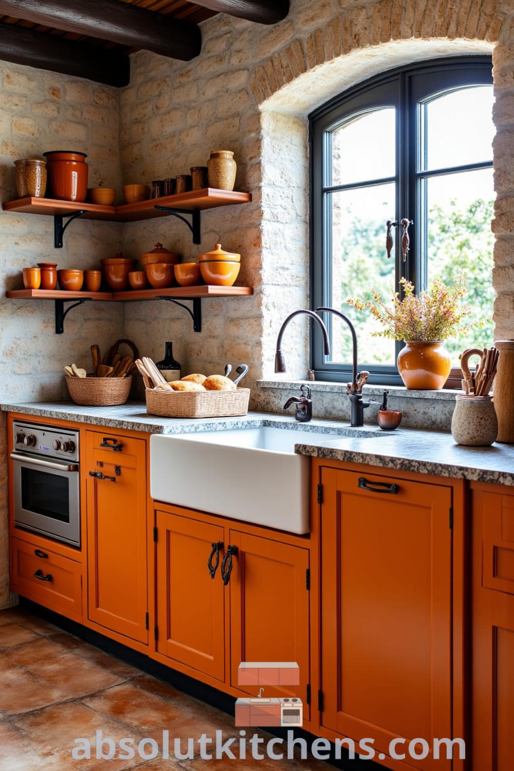 Cozy rustic kitchen with warm orange wooden cabinets, textured stone walls, artisan ceramics on open shelves, and a farmhouse sink under a window, creating inviting decor ideas and inspiration for home design at fireplacesandwoodstoves.com.